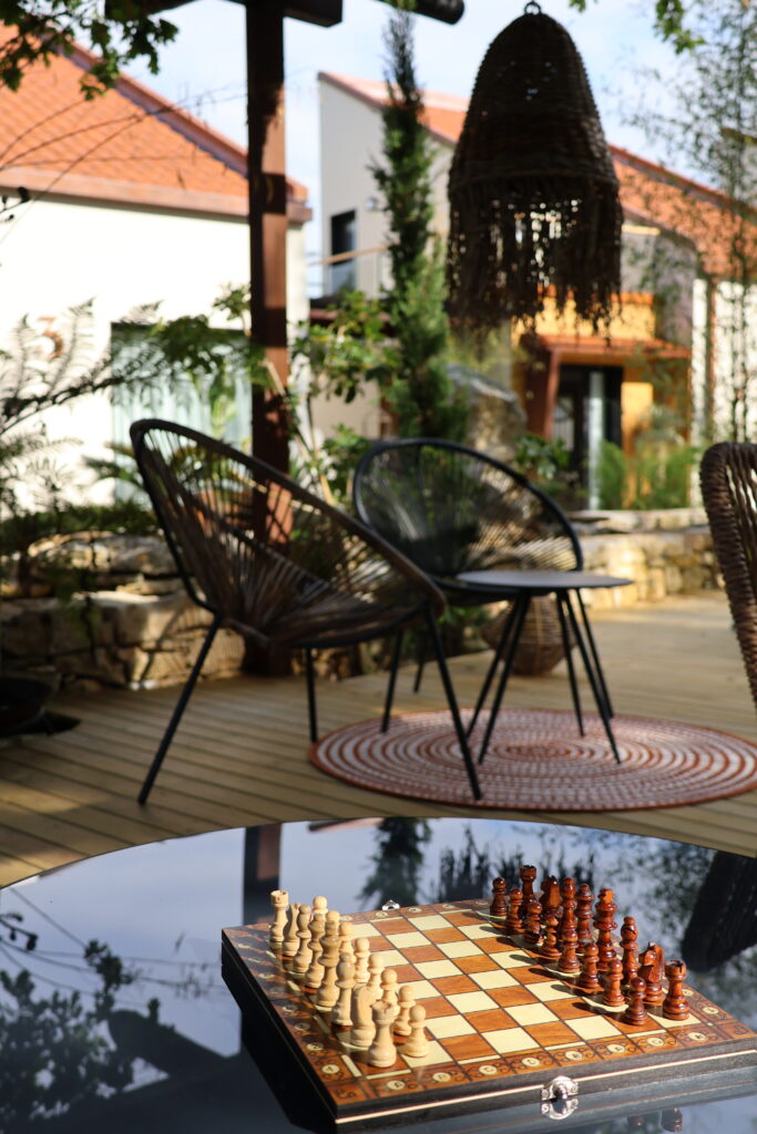 Chairs and chess in the outdoor common areas Villaverde Village